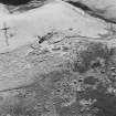 Oblique aerial view of Bairn's Hill centred on the remains of a farmhouse, farmsteading and township, taken from the NNE.