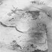 Oblique aerial view of White Hill centred on the remains of the enclosure and quarries, taken from the SW.