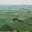 General oblique aerial view looking over the village of Clatt towards Bennachie, taken from the WNW.