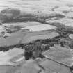 Oblique aerial view of Wardhouse Home Farm, centred on the remains of rig, small cairns and farmstead with hut-circles, small cairns, rig, cottages and quarry adjacent, taken from the NE.