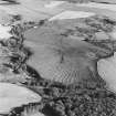 Oblique aerial view of Wardhouse Home farm centred on the remains of rig, small cairns and farmstead with cairns, field system, quarry and cottage adjacent, taken from the NW.