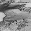 Oblique aerial view of Wardhouse Home Farm centred on the remains of hut-circles, small cairns and rig with rig, small cairns, farmstead, field-system, quarry and cottage adjacent, taken from the SE.