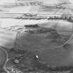 Oblique aerial view of Rosa Croft centred on the remains of cairns and field-system with small cairns and quarry adjacent, taken from the N.