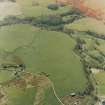 Oblique aerial view centred on the remains of the rig, small cairns, hut-circles and quarry, taken from the ESE.