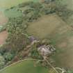 Oblique aerial view centred on the Home Farm with the ruins of the Country House adjacent, taken from the E.