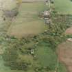 Oblique aerial view of the ruins of the Country House with the Home Farm adjacent, taken from the WSW.