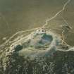 Oblique aerial view of Mither Tap of Bennachie centred on the remains of a fort, taken from the ESE.