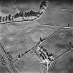 Tillyorn, oblique aerial view, taken from the W, showing the cropmark of a settlement enclosure in the centre of the photograph.