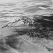 Oblique aerial view centred on the remains of quarries taken from the NNW.