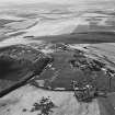 Oblique aerial view centred on the remains of quarries taken from the ESE.