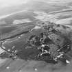 Oblique aerial view centred on the remains of quarries taken from the ENE.