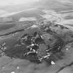 Oblique aerial view centred on the remains of quarries, taken from the NE.