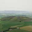 General oblique aerial view looking across the remains of the quarries towards Bennachie, taken from the NNW.