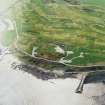 Oblique aerial view centred on the remains of the coastal battery with breakwaters adjacent, taken from the N.