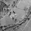Oblique aerial view centred on the remains of the abbey and the house and walled garden, taken from the SW.