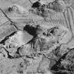 Oblique aerial view of Culbuirg, taken from the north east, centred on rig and field system.