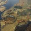 Oblique aerial view of Anie centred on a farmstead, the remains of a field-system, rig, military road and limekiln, taken from the SE.