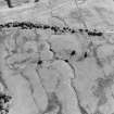 Oblique aerial view centred on the remains of the township and rig, taken from the N.