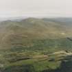 General oblique aerial view looking across the farmstead of Carie towards Ben Lawers, taken from the SSE.