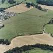 Dalginross, oblique aerial view, taken from the WNW, centred on the cropmarks of the Roman Fort and the Temporary Camp.