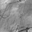 Oblique aerial view of Craggish centred on the cropmarks of a pit-defined cursus and several pits, taken from the NNW.