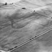 Oblique aerial view of Craggish centred on the cropmarks of a pit-defined cursus and several pits, taken from the WNW.