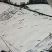 Oblique aerial view centred on temporary camps and fort under cover of snow.