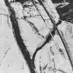 Oblique aerial view centred on the remains of the township buildings with the house and bridges adjacent, taken from the SE.