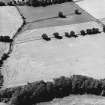 Lagg, oblique aerial view, taken from the E, centred on a complex of cropmarks which include a barrow, square barrow and pits.