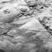 Corrymuckloch, oblique aerial view, taken from the ESE, showing the Crieff to Dalnacardoch military road running across the centre of the photograph. An area of hut-circles, clearance cairns and field banks is visible in the centre. A hoard find spot, in peat cuttings, is visible as a dark patch in the centre left of the photograph.