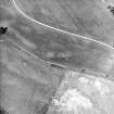 Monzie, oblique aerial view, taken from the S, centred on the cropmarks of a barrow, possible ring-ditch and moated site.