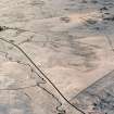 Oblique aerial photograph of Girron Burn centred on the remains of field-banks, rig and clearance cairns, taken from the ENE.