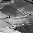 Oblique aerial view of Broich Road Farm centred on the cropmarks of a mortuary  enclosure, a possible pit-alignment, a possible pitted-enclosure and a series of pits, taken from the NNE.