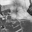 Oblique aerial view centred on the remains of trackways, field banks and sheepfold with standing stones adjacent, taken from the NW.