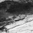 Oblique aerial view centred on the remains of a sheepfold, field banks and rig, taken from the E.