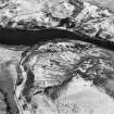 Oblique aerial view centred on the remains of the farmstead, head-dyke, field banks and rig, taken from the NE.