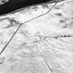 Oblique aerial view centred on the remains of the farmstead and enclosure with field-system adjacent, taken from the WSW.