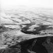 Oblique aerial view centred on the remains of the field-system, rig and trackway, taken from the WNW.