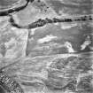 Belhie, oblique aerial view, taken from the NNW, centred on cropmarks including a ring-ditch, and an enclosure surrounding a standing stone.