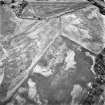 Belhie, oblique aerial view, taken from the SW, centred on cropmarks including a ring-ditch, and an enclosure surrounding a standing stone.