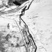 Oblique aerial view centred on the remains of buildings, enclosure, hut and lazy-beds with huts, enclosures, field-system, plantation bank, sheepfold, quarry, trackways, farmstead and field banks adjacent, taken from the WSW.