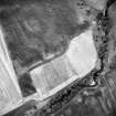 Oblique aerial view centred on the site of the enclosed cremation cemetery with the cropmarks of the enclosure adjacent, taken from the S.