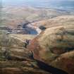 General oblique aerial view centred on the reservoir and dam, taken during low water from the E.