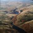 General oblique aerial view centred on the reservoir and dam, taken during low water from the ESE.