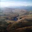 General oblique aerial view centred on the reservoir and dam, taken during low water from the ENE.