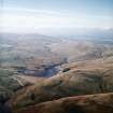 General oblique aerial view centred on the reservoir and dam, taken during low water from the ENE.