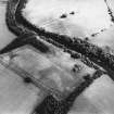 Oblique aerial view of Innerpeffray centred on the remains of the tower house and the cropmarks of a possible garden, a fort, and a pit-alignment, taken from the WNW.