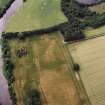 Oblique aerial view of Innerpeffray centred on the remains of the tower house and the cropmarks of a possible garden, and a pit-alignment, taken from the E.