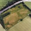 Oblique aerial view of Innerpeffray centred on the remains of the tower house and the cropmarks of a possible garden, a pit-alignment and a fort, taken from the NNE.