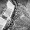 Oblique aerial view centred on the cropmarks of the possible enclosure, enclosure and enclosed cremation cemetery, taken from the SW.